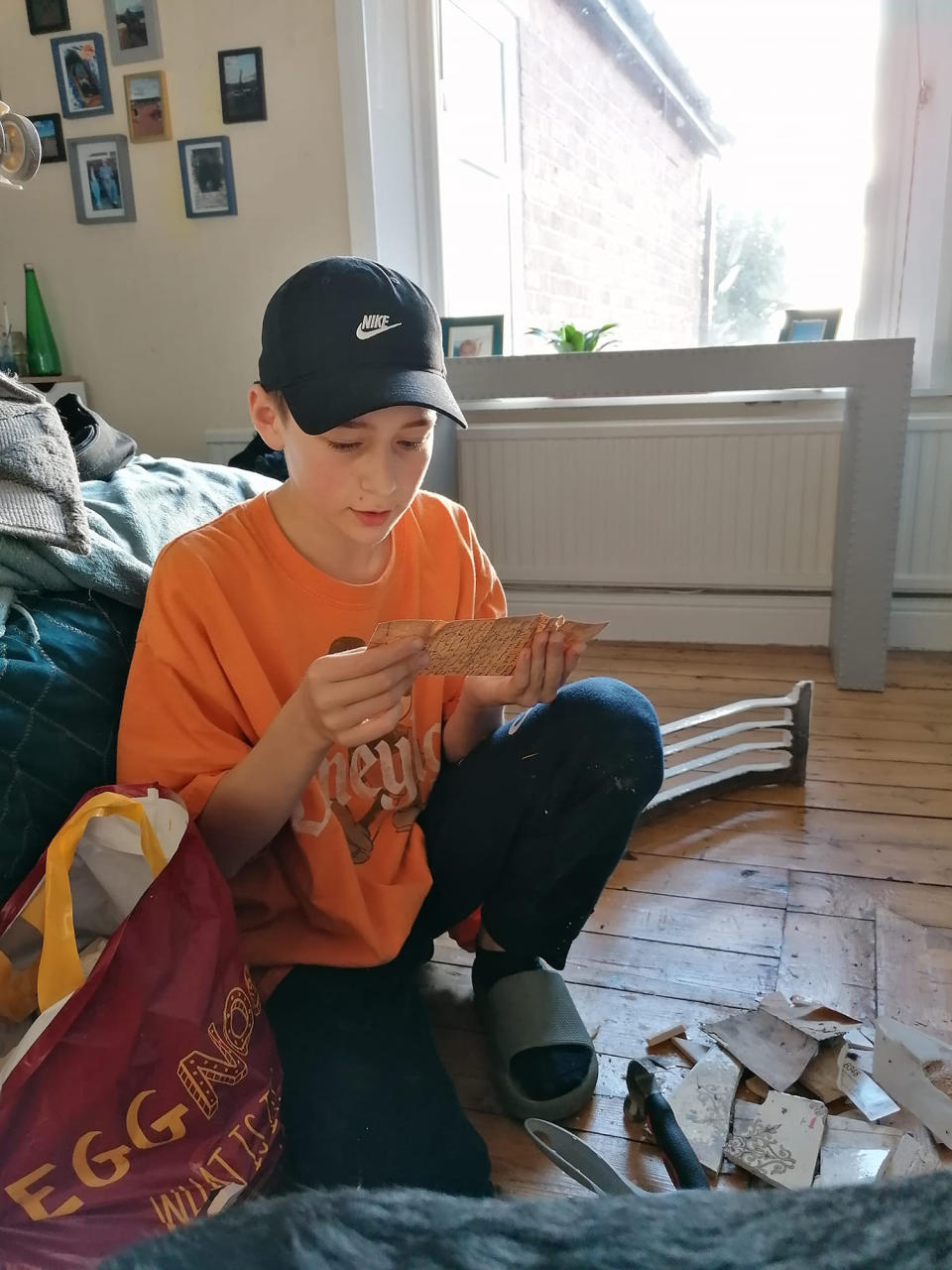 Loukas, 14, from Preston, reads the letter after finding it after a broken tile. Source: Jam Press/Australscope