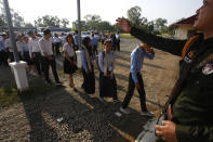 A court security officer, right, guides student as they enter into the courtroom before the hearings against two former Khmer Rouge senior leaders, at the U.N.-backed war crimes tribunal on the outskirts of Phnom Penh, Cambodia, Friday, Nov. 16, 2018. The U.N.-backed tribunal judging the criminal responsibility of former Khmer Rouge leaders for the deaths of an estimated 1.7 million Cambodians will issue verdicts Friday in the latest — and perhaps last — of such trials. (AP Photo/Heng Sinith)