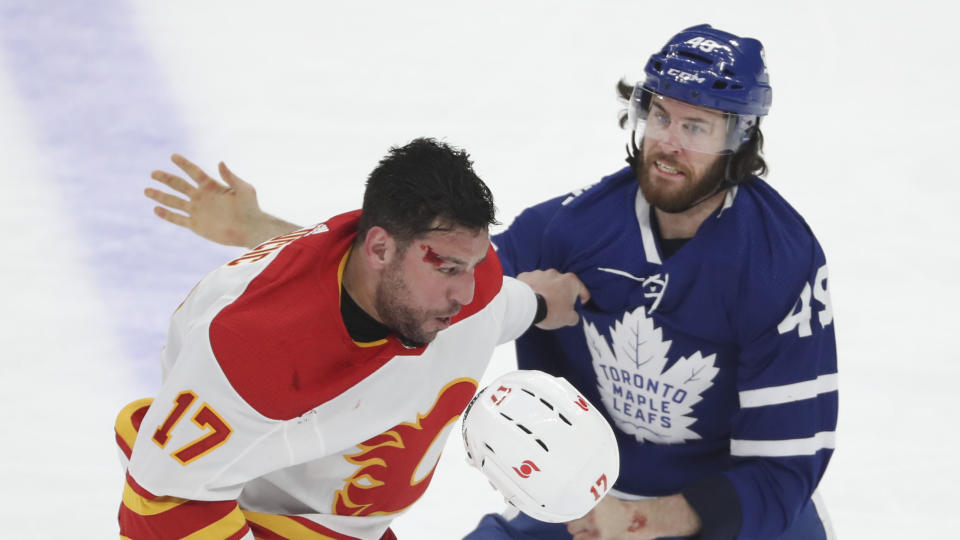 TORONTO, ON - April 13  In first period action, Toronto Maple Leafs right wing Scott Sabourin (49) and Calgary Flames left wing Milan Lucic (17) mix it up at centre ice.  
The Toronto Maple Leafs took on the Calgary Flames in NHL hockey action at the Scotiabank arena in Toronto.
April 13 2021        (Richard Lautens/Toronto Star via Getty Images)