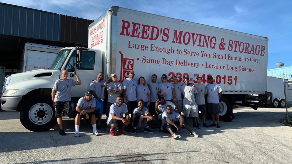 Reed's Moving & Storage employees standing in front of a moving truck