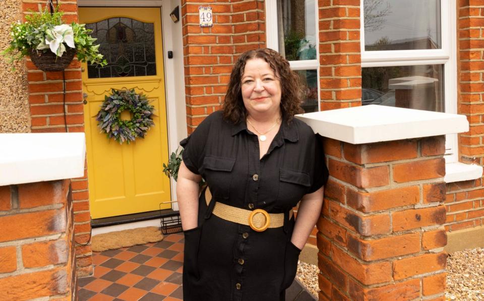 Charlotte Brown in front of home