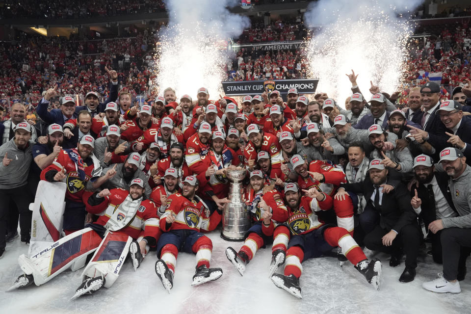 The Florida Panthers team poses with the Stanley Cup trophy after defeating the Edmonton Oilers in Game 7 of the NHL hockey Stanley Cup Final, Monday, June 24, 2024, in Sunrise, Fla. The Panthers defeated the Oilers 2-1. (AP Photo/Wilfredo Lee)