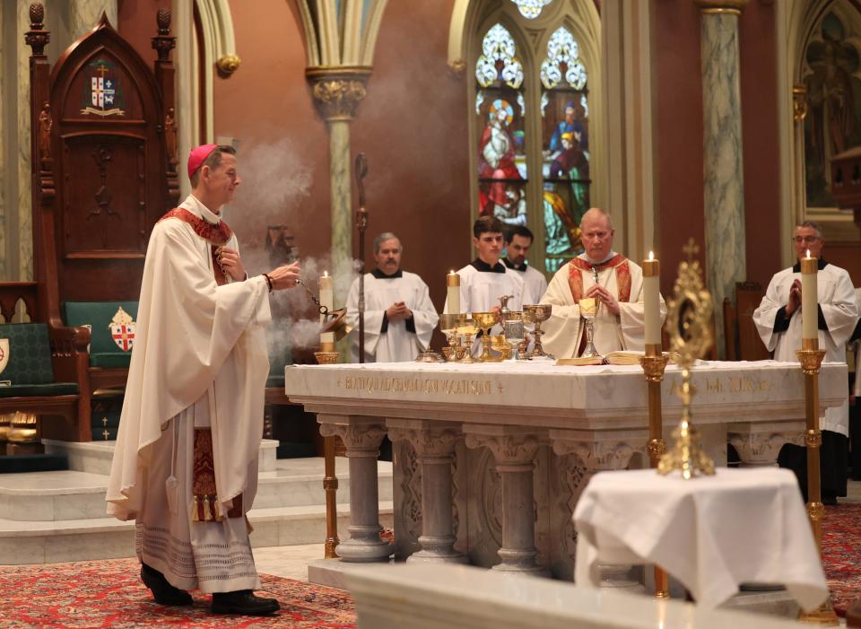 Bishop Stephen Parkes sanctifies the alter for Holly Communion during the St. Patrick's Day Mass on Saturday, March 16, 2024 at the Cathedral Basilica of St. John the Baptist.