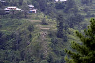 An empty cable car dangles hundreds of meters above the ground, in Pashto village, a mountainous area of Battagram district in Pakistan's Khyber Pakhtunkhwa province, Wednesday, Aug. 23, 2023. The rescue of six school children and two adults who were plucked from a broken cable car that was dangling precariously hundreds of meters (yards) above a steep gorge was a miracle, a survivor said Wednesday. The teenager said he and the others felt repeatedly that death was imminent during the 16-hour ordeal. (AP Photo/Saqib Manzoor)