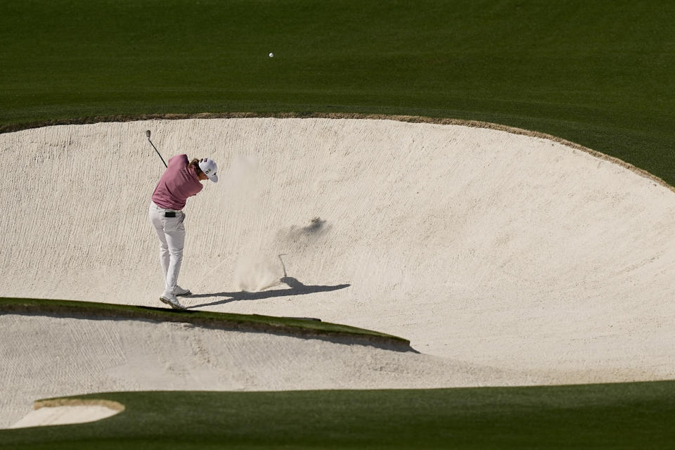 Cameron Smith, of Australia, hits out of a bunker on the eighth hole during the final round at the Masters golf tournament on Sunday, April 10, 2022, in Augusta, Ga. (AP Photo/David J. Phillip)