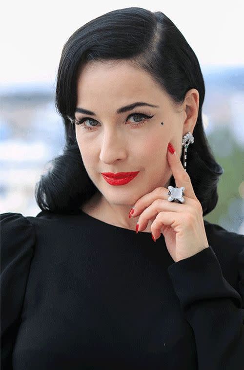 Dita Von Teese teasing us with her sultry cat eyes, porcelain skin and bright red pout at the Avakian suite at the Carlton Hotel in Cannes.
