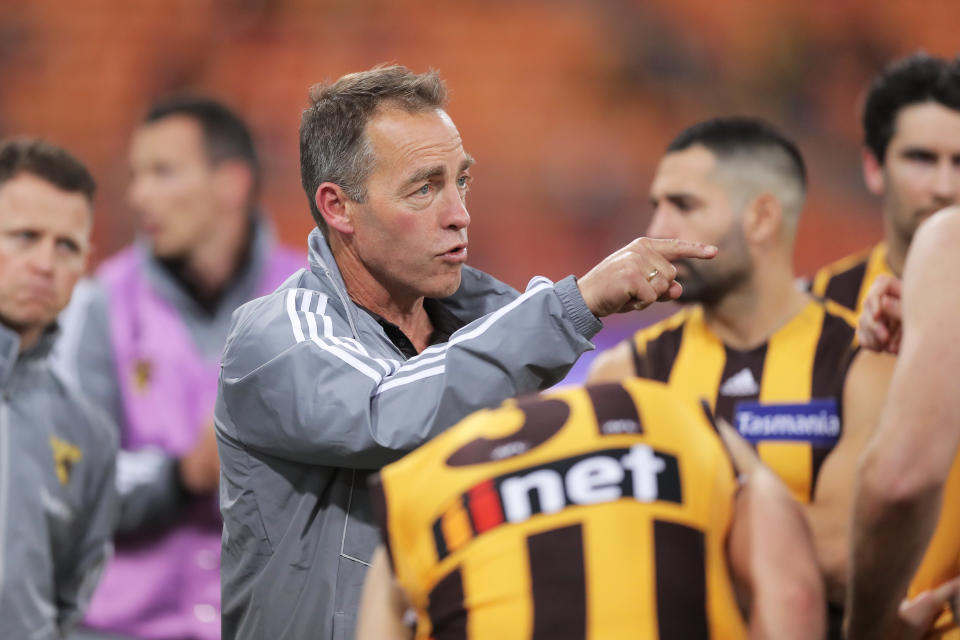 Hawks head coach Alastair Clarkson speaks to players at three quarter time during the round 5 AFL match. 