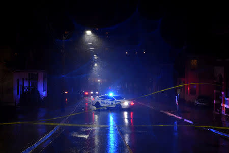 A police car blocks the scene of a downed power line as heavy rain and gusting winds from Winter Storm Grayson cause disruptions in Halifax, Nova Scotia, Canada January 4, 2018. REUTERS/Darren Calabrese