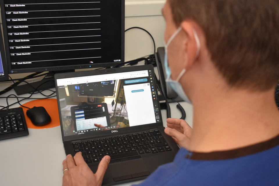 Medtronic senior technical consultant Stephen Clarke looks at the video feed from the smart glasses on a laptop (Royal Papworth Hospital/PA)