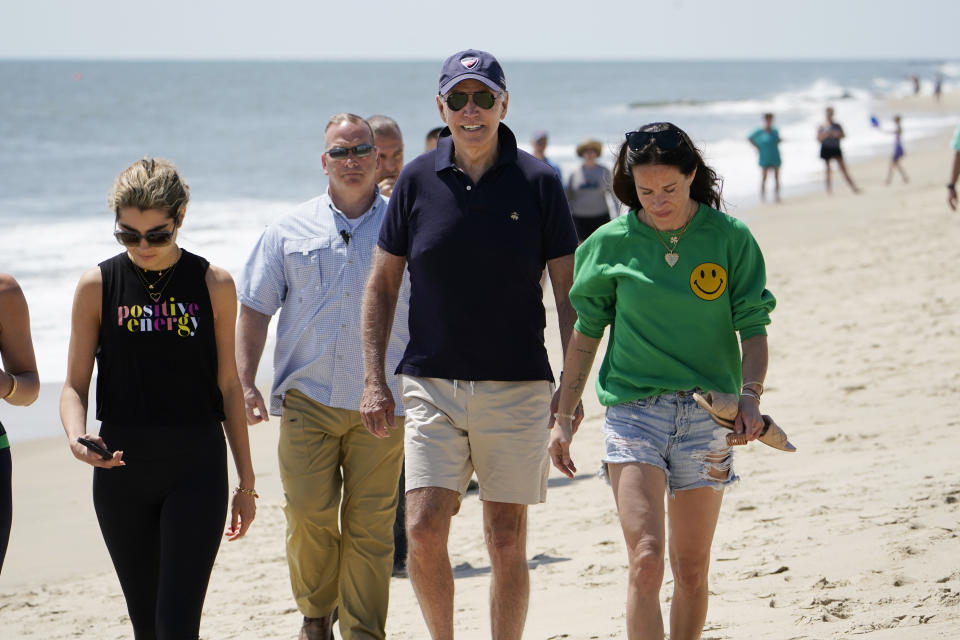 FILE - President Joe Biden walks on the beach with his granddaughter Natalie Biden, left, and his daughter Ashley Biden, right, Monday, June 20, 2022, at Rehoboth Beach, Del. The president spent all or part of 197 days in his home state of Delaware, traveling most weekends to either his home near Wilmington or his vacation home at Rehoboth Beach, according to an AP tally. (AP Photo/Manuel Balce Ceneta, File)