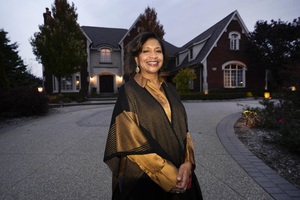 Alison Jones poses for a portrait outside her home in Rochester, Mich., Wednesday, Oct. 14, 2020. Trump’s description of the suburbs seems to Jones like nostalgia for “a `Leave it to Beaver’ time” when people who look like her could not have lived in her subdivision, where no house costs less than $1 million. (AP Photo/Paul Sancya)