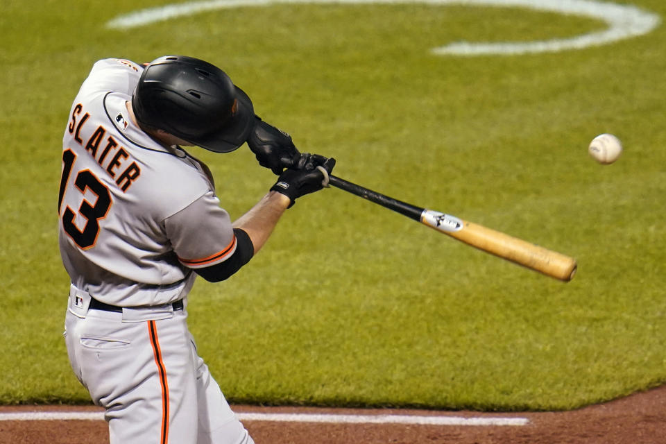 San Francisco Giants' Austin Slater drives in a run with a single off Pittsburgh Pirates relief pitcher Luis Oviedo during the 11th inning of a baseball game in Pittsburgh, Friday, May 14, 2021. (AP Photo/Gene J. Puskar)