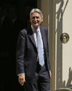 Britain's Chancellor of the Exchequer Philip Hammond leaves Downing Street, in London, Wednesday, July 24, 2019. Boris Johnson will replace Prime Minister Theresa May as Prime Minister later Wednesday, and begin to assemble his own government Cabinet team. (AP Photo/Tim Ireland)