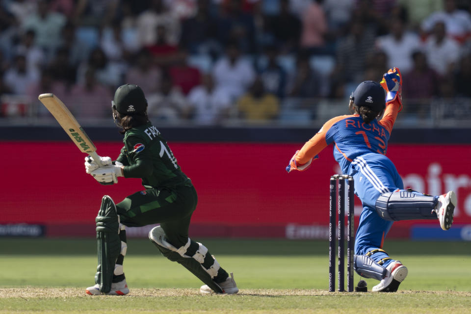 India's wicketkeeper Richa Ghosh, right, dives to takes the catch to get the wicket of Pakistan's captain Fatima Sana during the ICC Women's T20 World Cup 2024 match between Pakistan and India at Dubai International Stadium, United Arab Emirates, Sunday, Oct. 6, 2024. (AP Photo/Altaf Qadri)