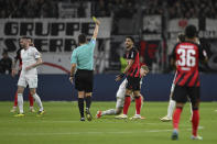 Referee Robert Hartmann shows Frankfurt's Omar Marmoush a yellow card during the Bundesliga soccer match between Eintracht Frankfurt and Werder Bremen at the Deutsche Bank Park stadium in Frankfurt, Germany, Friday April 5, 2024. (Arne Dedert/dpa via AP)