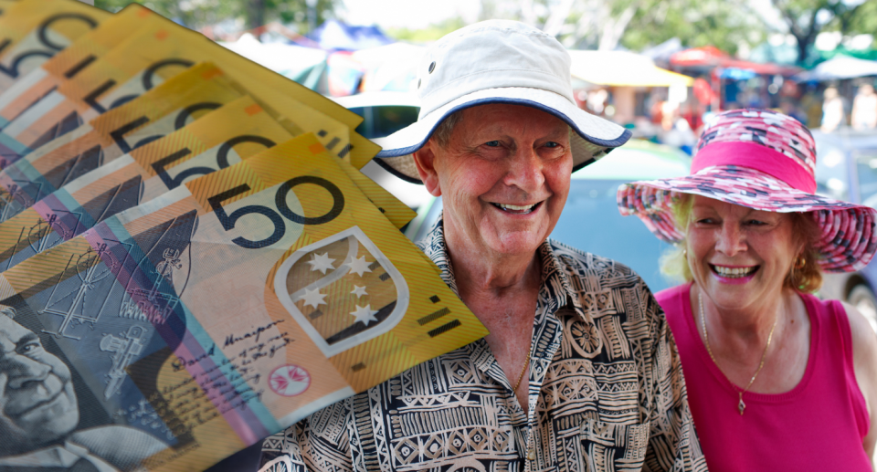 Wad of $50 notes next to Baby Boomer couple