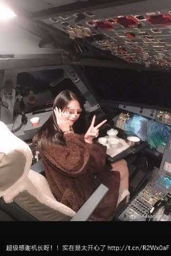 An image of a woman sitting in the cockpit of the plane. 