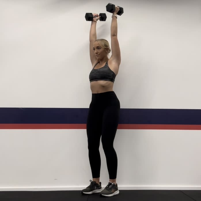 Personal trainer Klaudia Lucia demonstrating a squat to press