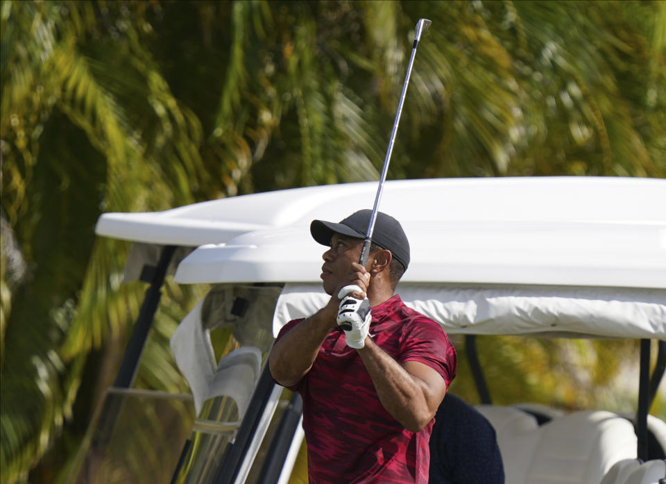 Tiger Woods watches his shot during a training session at the Albany Golf Club, in New Providence, Bahamas, Sunday, Dec. 5, 2021.(AP Photo/Fernando Llano)