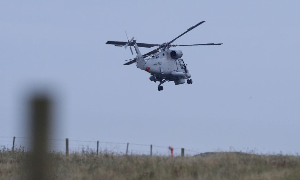 A New Zealand Navy helicopter takes off from Whakatane Airport as the mission to return victims of the White Island eruption begins in Whakatane, New Zealand, Friday, Dec. 13, 2019. A team of eight New Zealand military specialists landed on White Island early Friday to retrieve the bodies of victims after the Dec. 9 eruption. (AP Photo/Mark Baker)