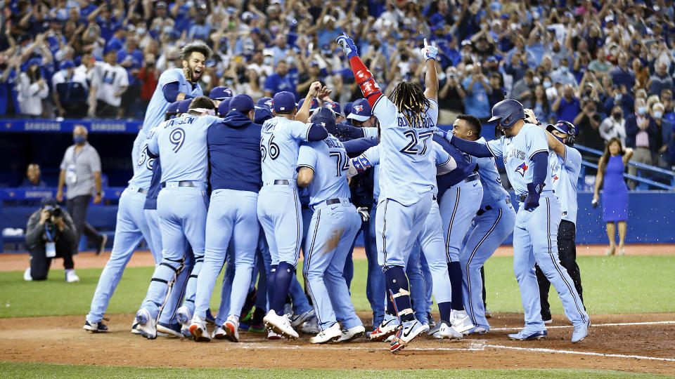 Marcus Semien #10 of the Toronto Blue Jays celebrates with teammates after hitting a walk-off home run against the Oakland Athletics. (Photo by Vaughn Ridley/Getty Images)