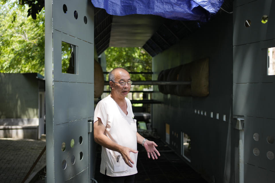 Thai veterinarian Visit Arsaithamkul gestures as he stands by the container which will carry the Asian elephant Sak Surin gifted by the Thai Royal family and named Muthu Raja or pearly king in Sri Lanka at the national zoological garden in Colombo, Sri Lanka, Friday, June 30, 2023. Sak Surin, or the honor of the Thai province of Surin, spends its last hours in Sri Lanka its adopted home, awaiting to be airlifted back to its country of birth after alleged abuse. (AP Photo/Eranga Jayawardena)