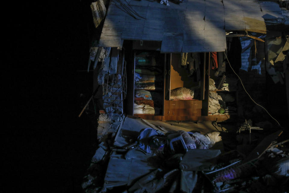 In this Tuesday Nov. 26, 2019 photo, a cupboard stands in a collapsed building in Thumane, western Albania following a deadly earthquake.(AP Photo/Petros Giannakouris)