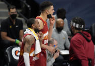 Denver Nuggets guard Monte Morris, front, and forward Michael Porter Jr. pull down their face masks to celebrate as time runs out in the team's NBA basketball game against the Miami Heat on Wednesday, April 14, 2021, in Denver. (AP Photo/David Zalubowski)