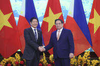 Philippine President Ferdinand Marcos Jr., left, and Vietnamese Prime Minister Pham Minh Chinh shake hands in Hanoi, Vietnam Tuesday, Jan. 30, 2024. Marcos is on a visit to Hanoi to boost the bilateral relation with the fellow Southeast Asian nation. (Hoang Thong Nhat/VNA via AP)