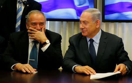 Avigdor Lieberman, head of far-right Yisrael Beitenu party, (L) sits next to Israeli Prime Minister Benjamin Netanyahu as they sign a coalition deal to broaden the government's parliamentary majority, at the Knesset, the Israeli parliament in Jerusalem May 25, 2016. REUTERS/Ammar Awad