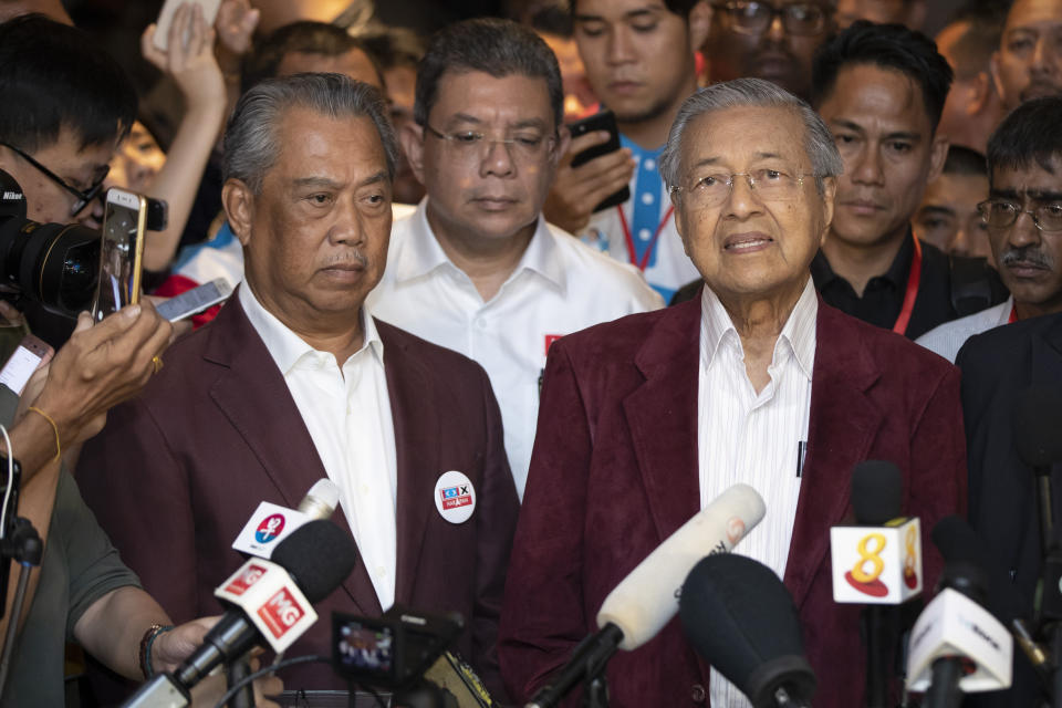 In this May 9, 2018, photo, Mahathir Mohamad, right, speaks to media during a press conference to announce victory on election as Muhyiddin Yassin, president of Malaysian United Indigenous Party stands next to him at a hotel in Kuala Lumpur, Malaysia. Malaysian ex-Prime Minister Mahathir has been ousted from his Malay party in the latest twist to a power struggle with his successor Muhyiddin Yassin, but he has vowed to challenge it. (AP Photo/Vincent Thian)