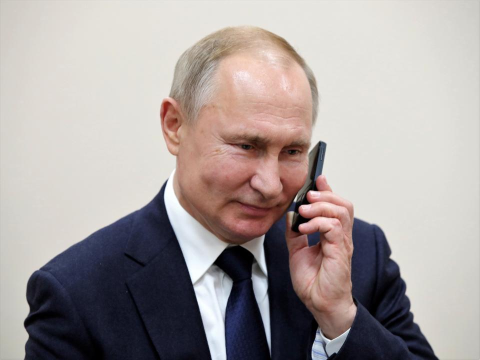 Russian President Vladimir Putin talks on the phone in the settlement of Enem, Republic of Adygea, Russia, on 23 December, 2019 (Reuters)