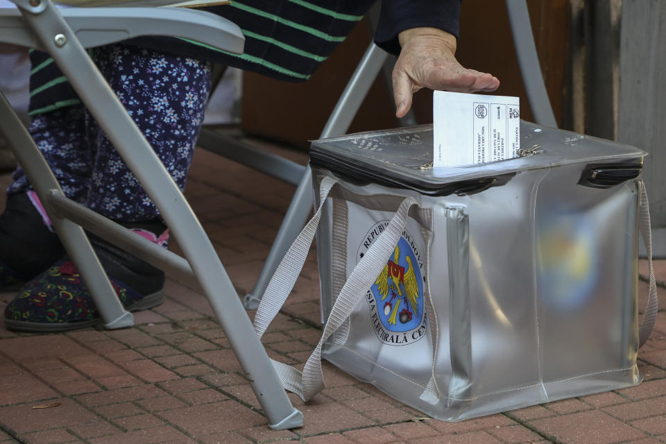 An elderly Moldovan woman casts her vote into a mobile urn during local elections in Chisinau, Moldova, Sunday, Nov. 5, 2023. Moldovans are casting ballots in nationwide local elections amid claims by Moldovan authorities that Russia has been conducting “hybrid warfare” to undermine the vote in the European Union candidate country. (AP Photo/Aurel Obreja)