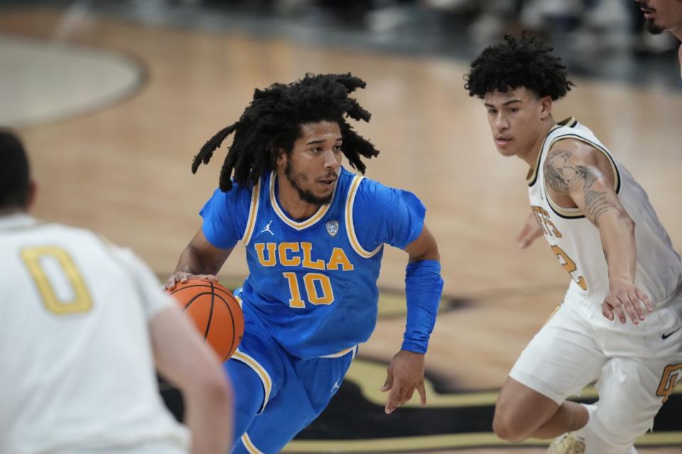 UCLA guard Tyger Campbell and Colorado guard KJ Simpson in the first half.