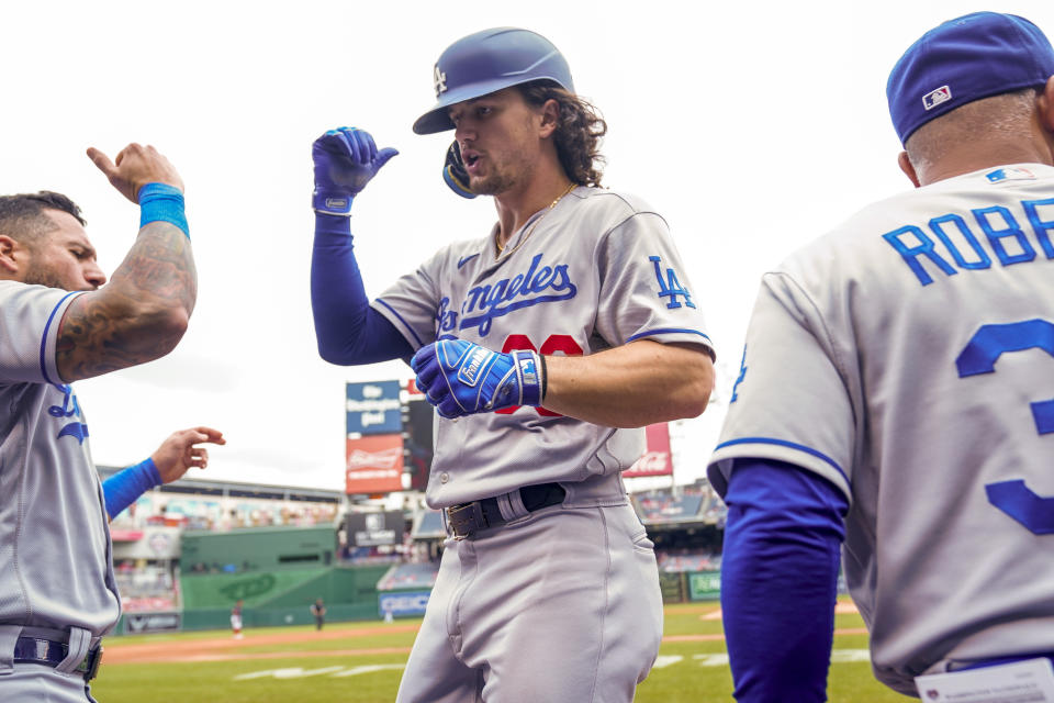 Los Angeles Dodgers' James Outman celebrates with teammates in the dugout after hitting a solo home run in the second inning of a baseball game against the Washington Nationals at Nationals Park, Sunday, Sept. 10, 2023, in Washington. (AP Photo/Andrew Harnik)