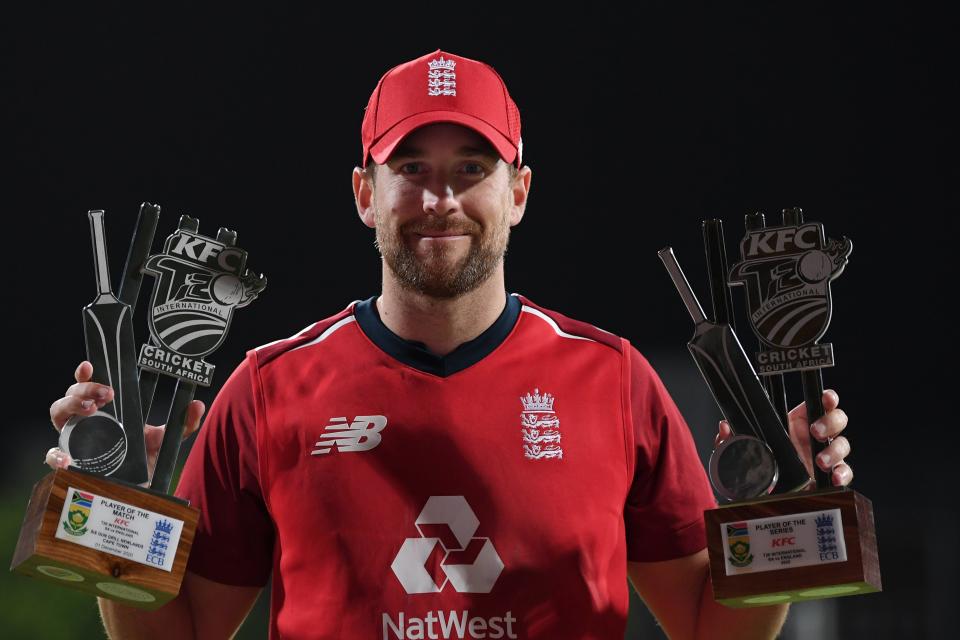 <p>Dawid Malan poses with his player of the match and player of the series trophies in Cape Town</p> (Getty Images)