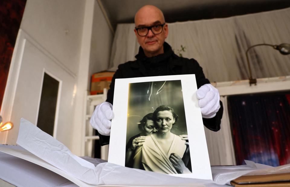 German photographer Boris Eldagsen shows a printed photograph of his work "Pseudomnesia: The Electrician" which he had created with the usage of artificial intelligence.