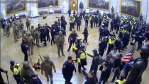 In this image from U.S. Capitol Police security video, police and rioters are seen in the Rotunda of the Capitol on Jan. 6, 2021, in Washington. New internal documents provided by former Facebook employee-turned-whistleblower Frances Haugen provide a rare glimpse into how the company, after years under the microscope for the policing of its platform, appears to have simply stumbled into the Jan. 6 riot. (U.S. Capitol Police via AP)