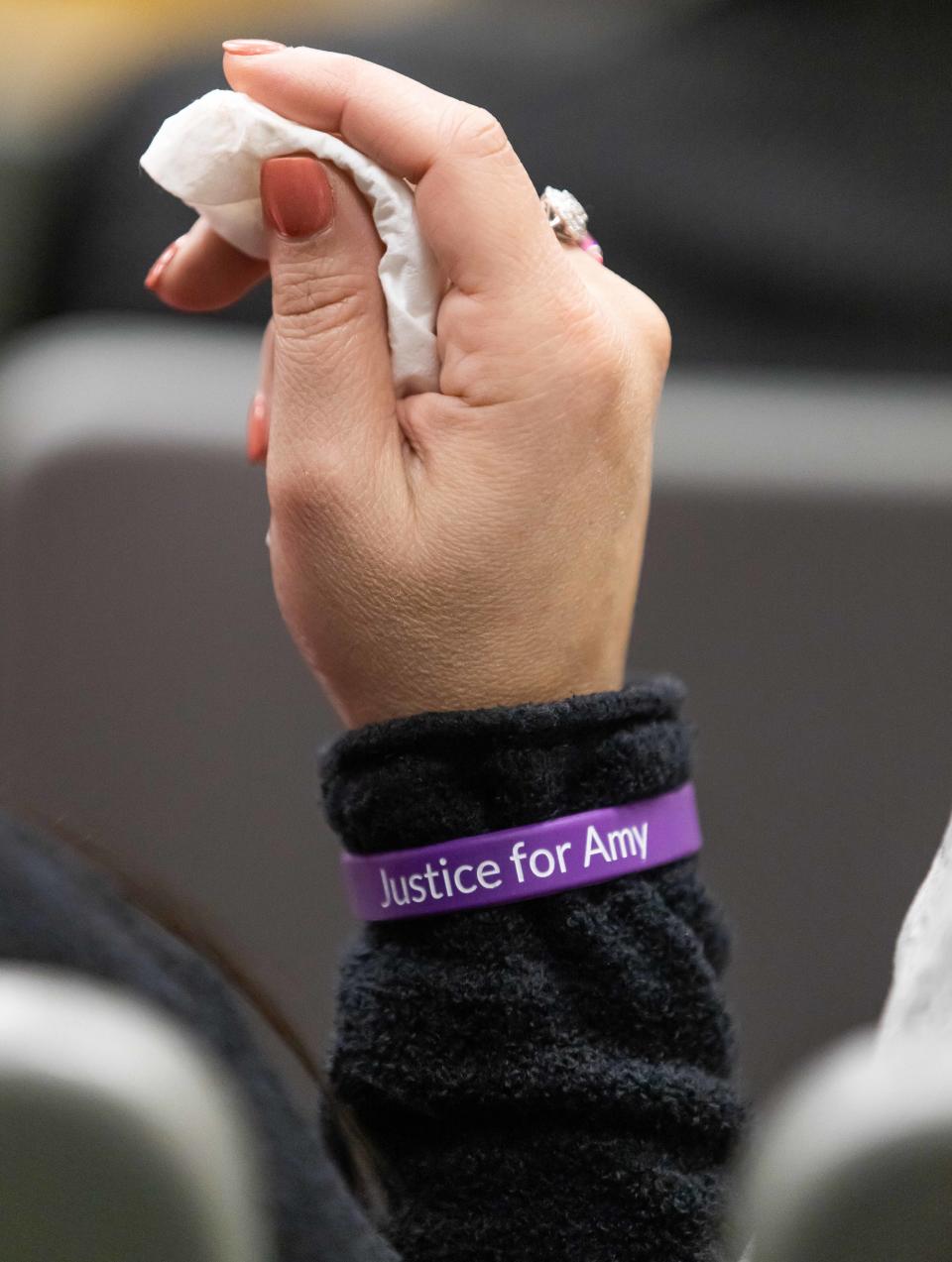 A family member of Amy Scott wears a bracelet in her honor during the Christopher Alan Smith trial Wednesday October 11, 2023. Smith is charged with second degree murder and aggravated battery with a deadly weapon. He's accused of killing Amy Scott. The trial was being held in Judge Peter Bringham’s courtroom at the Marion County Judicial Center in Ocala, Fla. [Doug Engle/Ocala Star Banner]2023