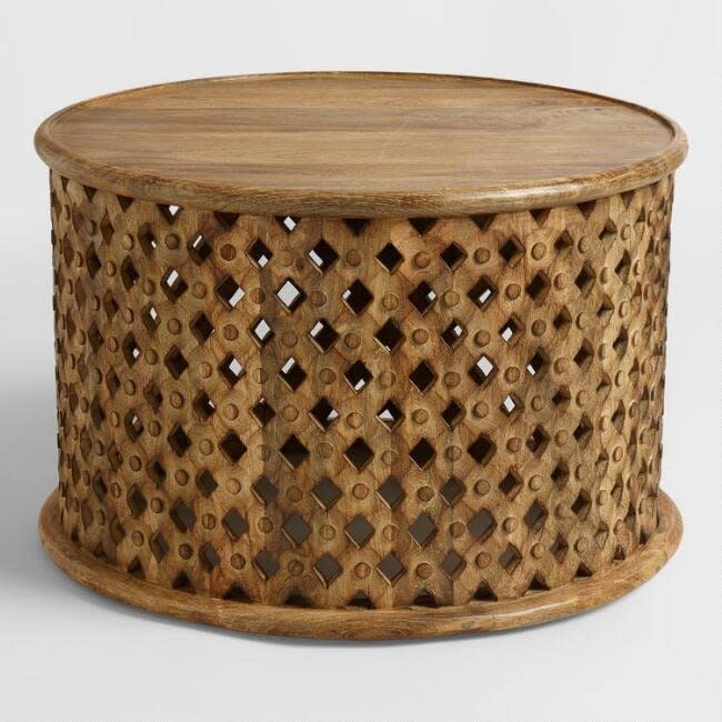 This <a href="https://www.worldmarket.com/product/tribal-carved-coffee-table.do?sortby=ourPicks&amp;from=fn" target="_blank">beautifully crafted coffee table</a> of mango wood makes for a perfectly symmetrical talking piece.&nbsp;&nbsp;