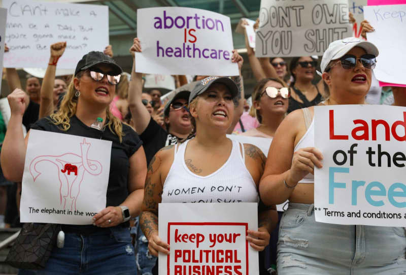 Women hold placards during a protest in support of abortion rights in Florida. Lauren Witte/Tampa Bay Times via ZUMA Press/dpa