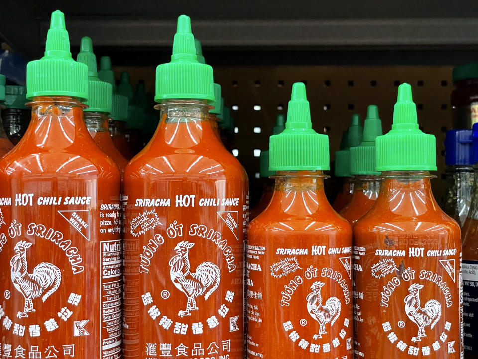 LARKSPUR, CALIFORNIA - JUNE 10: Bottles of Huy Fong Foods Sriracha sauce are displayed on a supermarket shelf on June 10, 2022 in Larkspur, California. Due to a shortage of the chili peppers used to make Sriracha hot sauce, the popular condiment is becoming hard to find on store shelves. Huy Fong Foods announced that it will temporarily suspend production and will be unable to fill orders placed after mid-April. (Photo by Justin Sullivan/Getty Images)