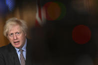 Britain's Prime Minister Boris Johnson leads a virtual press conference on the Covid-19 pandemic, inside 10 Downing Street in central London Tuesday Jan. 26, 2021. Official data shows that more than 100,000 people have died after testing positive for coronavirus in Britain, since the pandemic took hold last year. (Justin Tallis / Pool via AP)