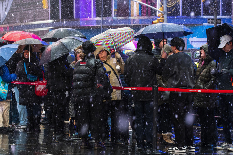 People make their way around Times Square during a winter storm in New York, Sunday, Jan. 7, 2024. (AP Photo/Eduardo Munoz Alvarez)