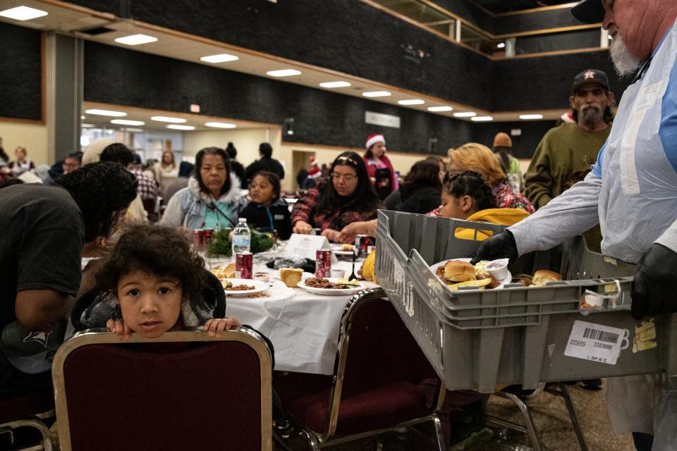 Marocco Edwards, 3, leans on the back of his chair while his family eats at the American Bank Center during the H-E-B Feast of Sharing event on Dec. 23, 2022, in Corpus Christi, Texas. 