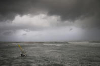 Wind surfers ride on waves in the Mediterranean Sea in Tel Aviv, Israel, Wednesday, Jan. 16, 2019. A harsh weather front brought sandstorms, hail and rain to parts of the Middle East, with visibility down in The Egyptian capital as an orange cloud of dust blocked out the sky. Dusty winds whipped through Israel and the West Bank as well on Wednesday, with hail falling near Tel Aviv and meteorologists announcing that snow was expected later in the day in Jerusalem. (AP Photo/Oded Balilty)