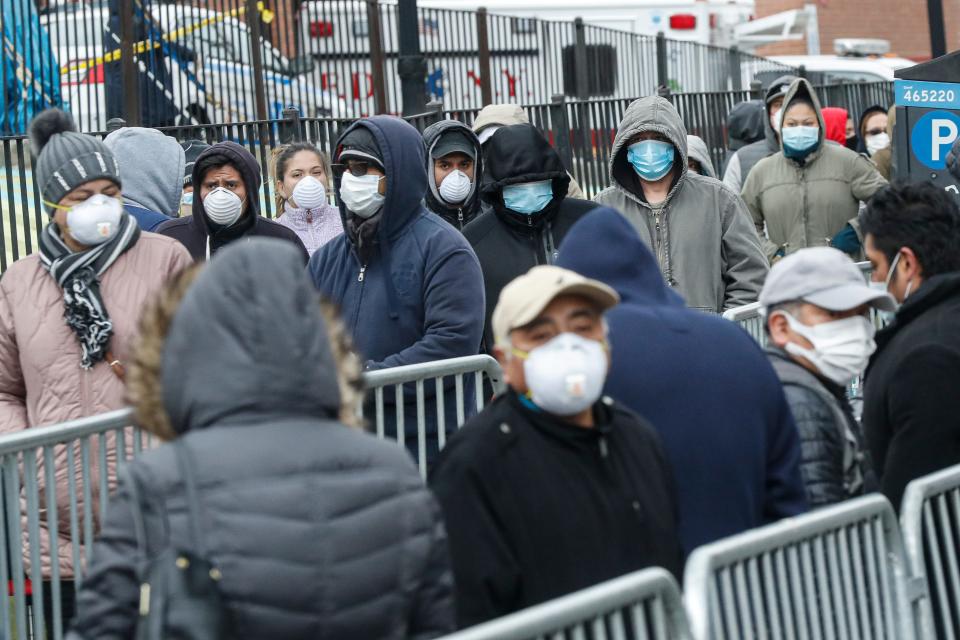 Patients wear personal protective equipment while maintaining social distancing as they wait in line for a COVID-19 test at Elmhurst Hospital Center in New York.