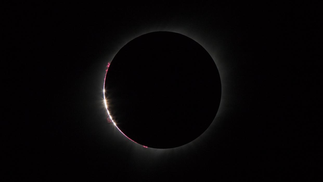  N event immediately preceding both ends of totality. Baily's Beads is a phenomenon in which the Sun's light passes through the mountains on the moon leading to the "beads" on the edge of the Moon's shadow. The Chromosphere is also quite visible in this shot. 