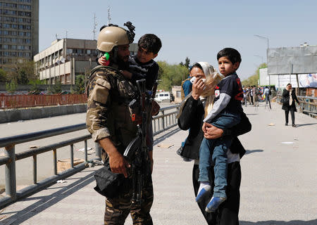 Rescued children are carried from the building of Ministry of Communication and Information Technology in Kabul, Afghanistan April 20, 2019.Reuters/Mohammad Ismail