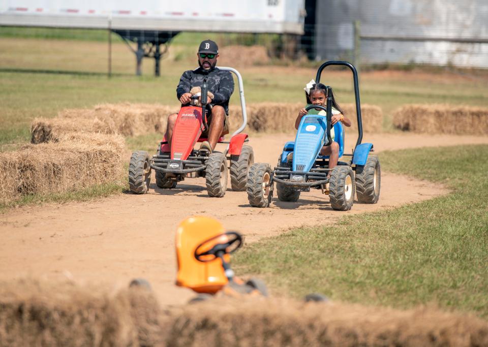 Visitors take a spin around Holland Town Speedway at Holland Farms Pumpkin Patch and Maze last year. Holland Farms also includes a hill slide, a train ride around the farm, corn boxes, horse rides and more.